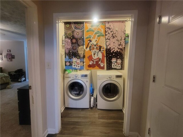 laundry area with dark wood-style floors, laundry area, baseboards, and separate washer and dryer