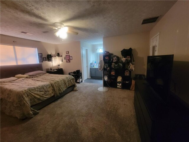 carpeted bedroom featuring a textured ceiling, ceiling fan, and ensuite bathroom