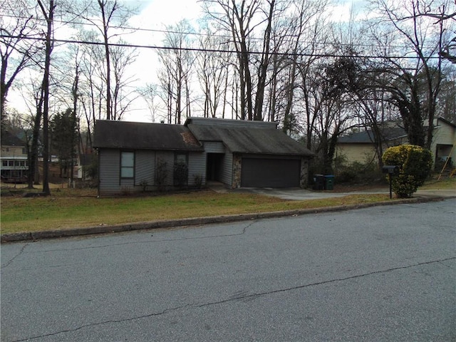 mid-century modern home featuring a garage and driveway