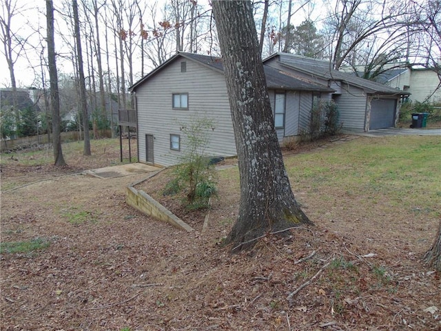 view of property exterior featuring driveway and an attached garage