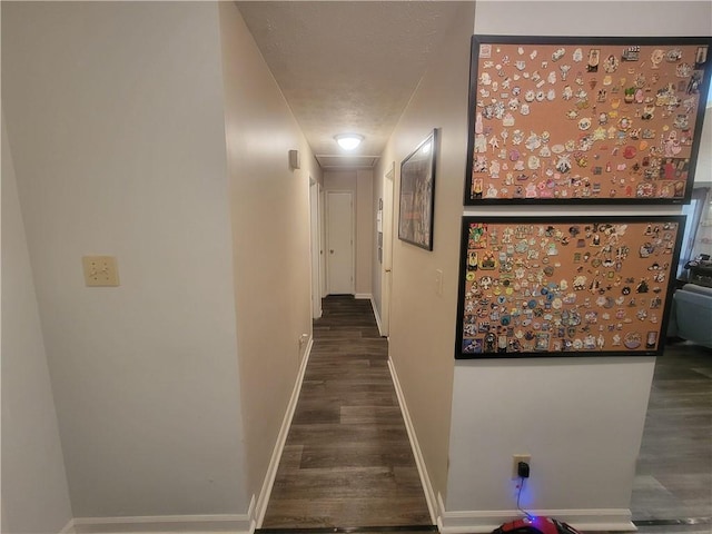 hallway with baseboards and wood finished floors