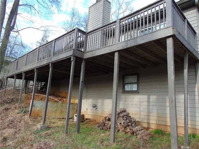 view of property exterior featuring a deck and a chimney