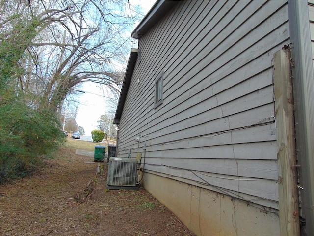 view of side of property with central air condition unit