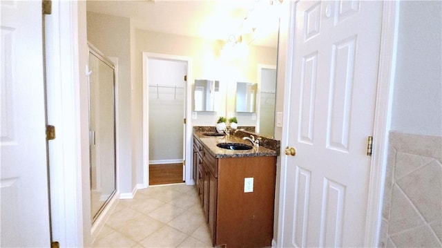 full bathroom featuring tile patterned floors, a sink, and a stall shower