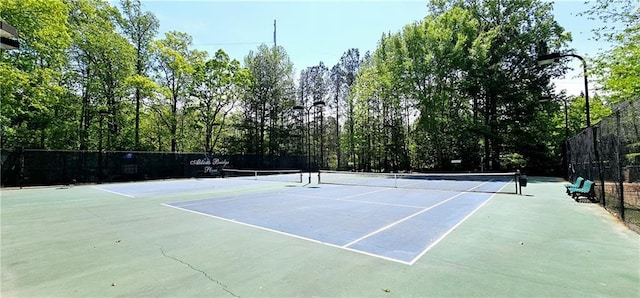 view of sport court featuring fence
