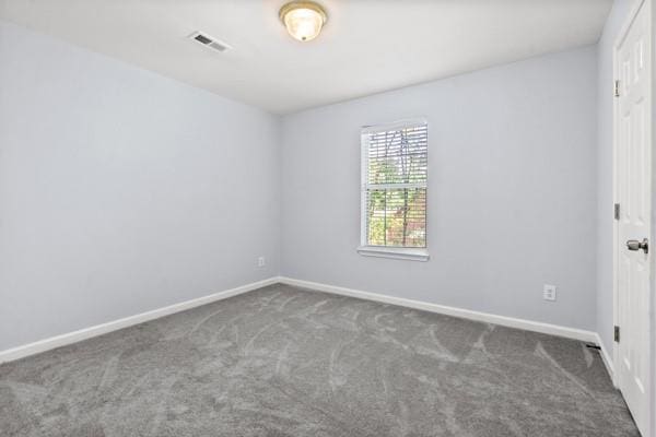 spare room with carpet and baseboards