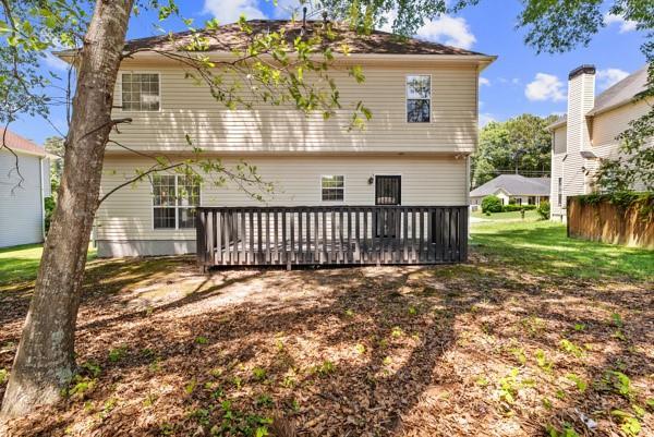 back of property with a wooden deck