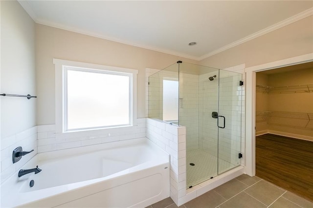 full bath with a garden tub, crown molding, a shower stall, and tile patterned floors