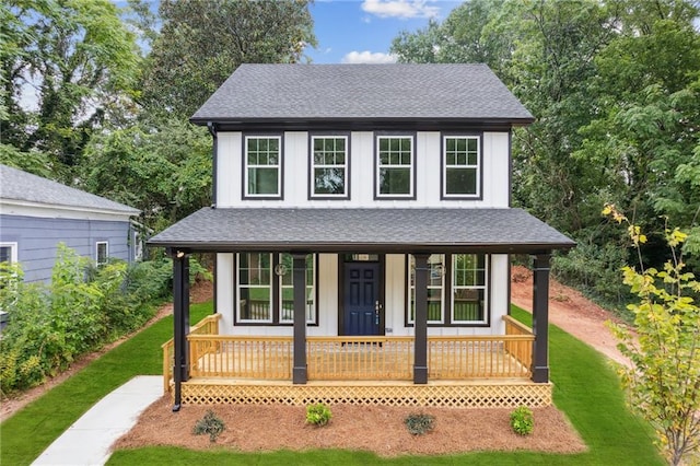 view of front of house with a front yard and covered porch