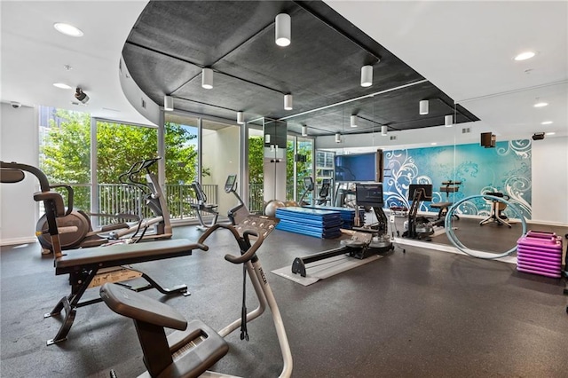 gym with a wall of windows