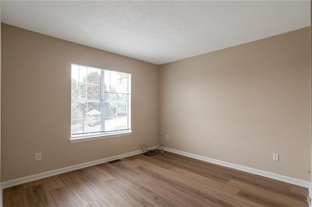 3984 Oak Glenn Dr, Duluth, GA 30096 - unfurnished room with light wood-type flooring, healthy amount of natural light, and baseboards