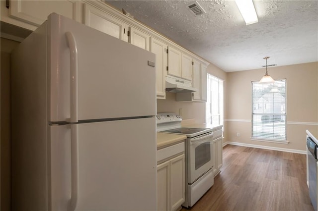 3984 Oak Glenn Dr, Duluth, GA 30096 - kitchen with white appliances, under cabinet range hood, wood finished floors, baseboards, and a textured ceiling
