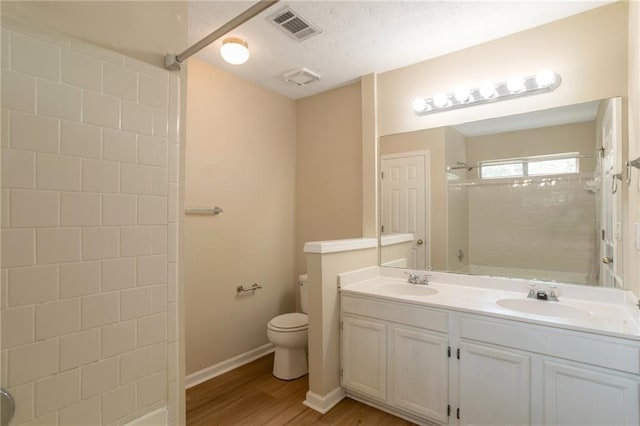 3984 Oak Glenn Dr, Duluth, GA 30096 - full bathroom featuring wood finished floors, double vanity, toilet, and baseboards