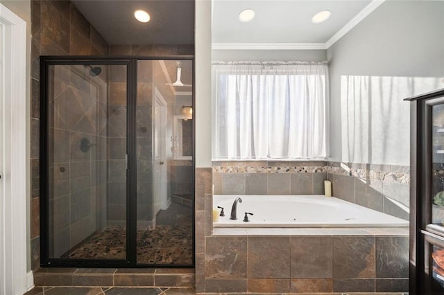 bathroom featuring shower with separate bathtub and ornamental molding