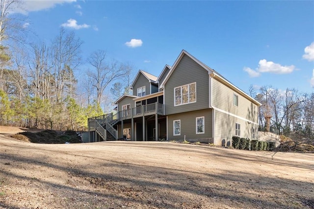 rear view of house featuring a wooden deck