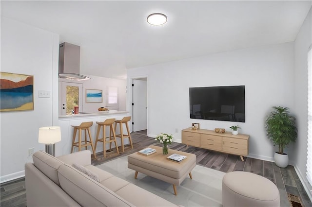 living room featuring wood finished floors and baseboards