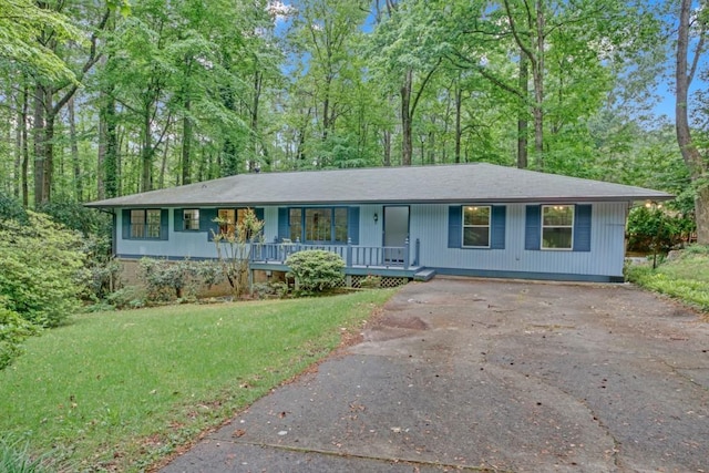 4856 Rock Haven Dr, Lilburn, GA 30047 - ranch-style house with a porch, driveway, and a front yard