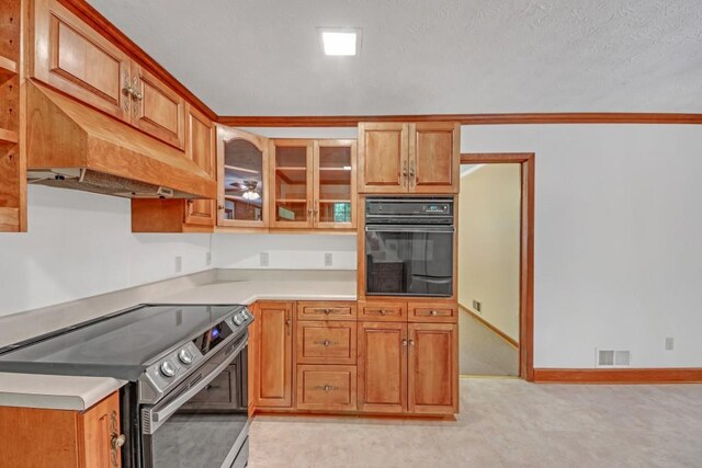 4856 Rock Haven Dr, Lilburn, GA 30047 - kitchen featuring electric range, black oven, light countertops, brown cabinetry, and glass insert cabinets