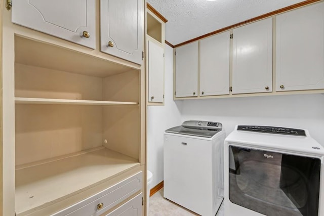 4856 Rock Haven Dr, Lilburn, GA 30047 - laundry area featuring cabinet space, washer and clothes dryer, and a textured ceiling