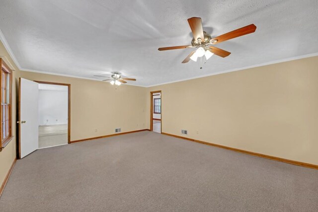 4856 Rock Haven Dr, Lilburn, GA 30047 - spare room with baseboards, a ceiling fan, crown molding, and light carpet