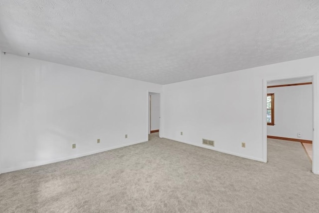 4856 Rock Haven Dr, Lilburn, GA 30047 - unfurnished room with a textured ceiling, light carpet, and baseboards