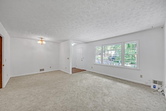4856 Rock Haven Dr, Lilburn, GA 30047 - spare room featuring carpet, baseboards, and a textured ceiling