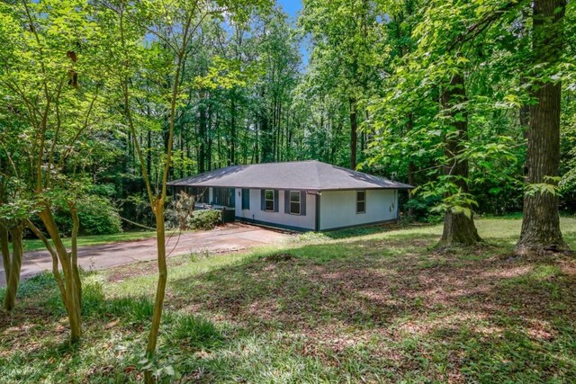 4856 Rock Haven Dr, Lilburn, GA 30047 - ranch-style house featuring driveway and a view of trees