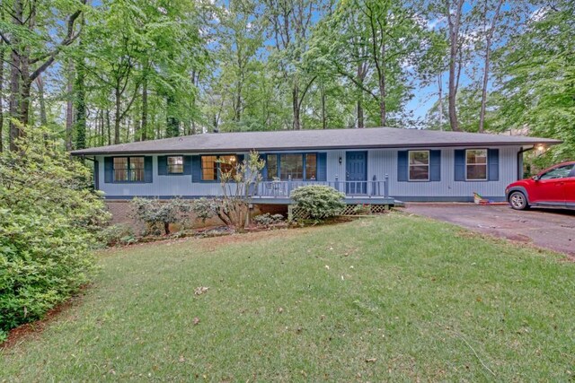 4856 Rock Haven Dr, Lilburn, GA 30047 - ranch-style house featuring covered porch, a front lawn, and driveway