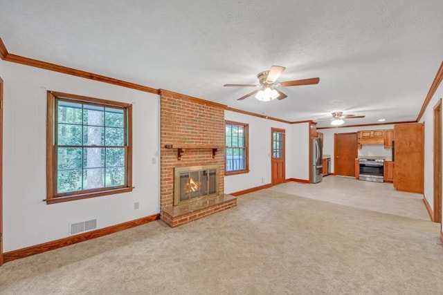 4856 Rock Haven Dr, Lilburn, GA 30047 - unfurnished living room featuring crown molding, healthy amount of natural light, a ceiling fan, baseboards, and light carpet