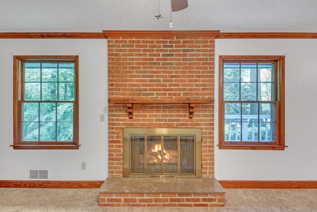 4856 Rock Haven Dr, Lilburn, GA 30047 - detailed view of carpet floors, baseboards, ceiling fan, ornamental molding, and a fireplace