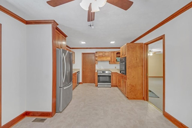 4856 Rock Haven Dr, Lilburn, GA 30047 - kitchen featuring appliances with stainless steel finishes, crown molding, a ceiling fan, light countertops, and baseboards