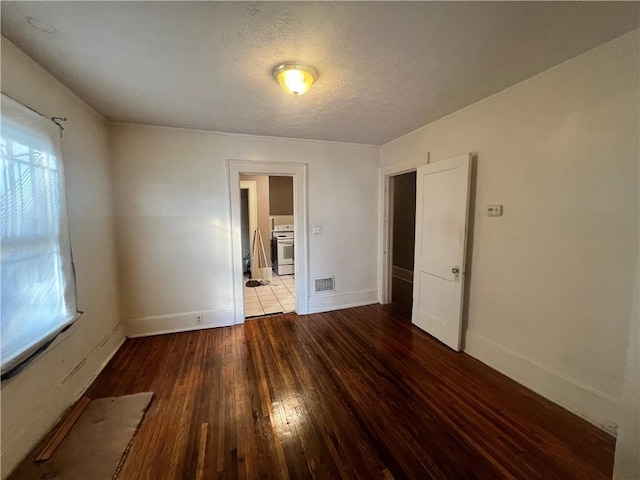 1165 Oak St SW, Atlanta, GA 30310 - empty room with wood-type flooring, plenty of natural light, baseboards, and a textured ceiling