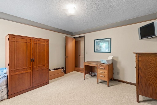 carpeted office space with a textured ceiling