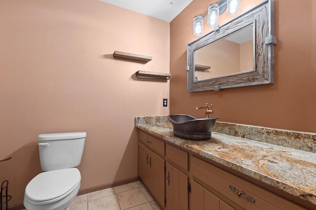 bathroom with vanity, tile patterned floors, and toilet