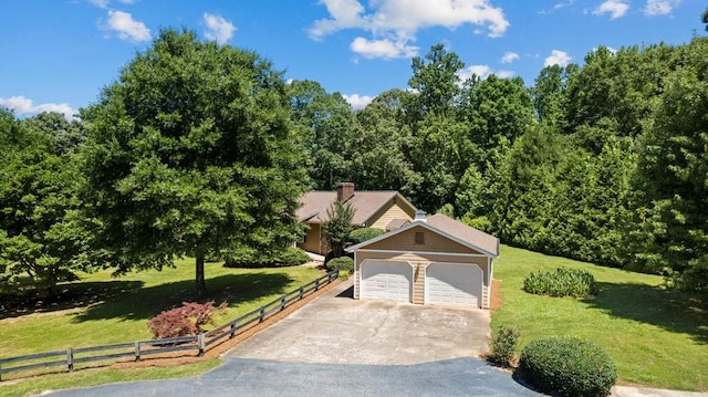 view of front of house featuring a garage and a front yard