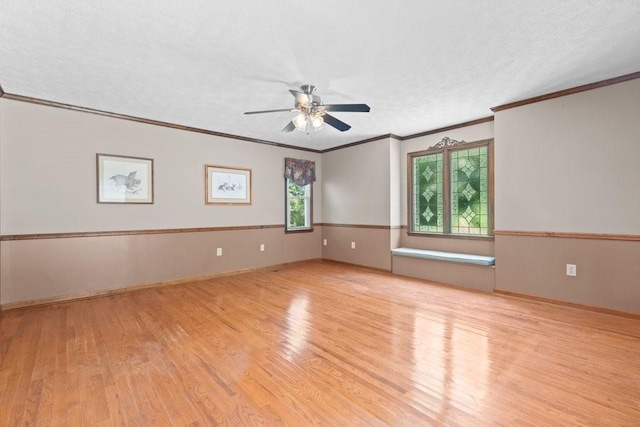 spare room featuring crown molding, a textured ceiling, ceiling fan, and light hardwood / wood-style flooring