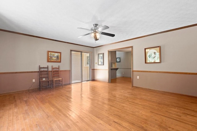 empty room featuring crown molding, light hardwood / wood-style floors, and ceiling fan