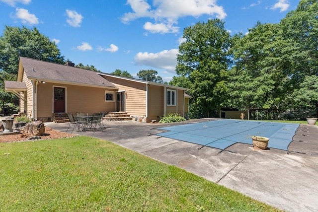 view of pool featuring a yard and a patio area