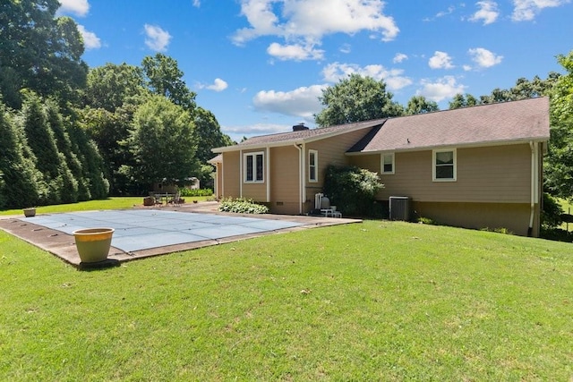 back of house featuring a yard, a patio area, and central air condition unit