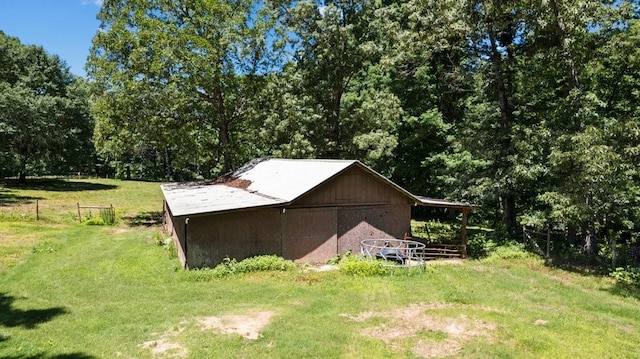 view of outbuilding featuring a lawn