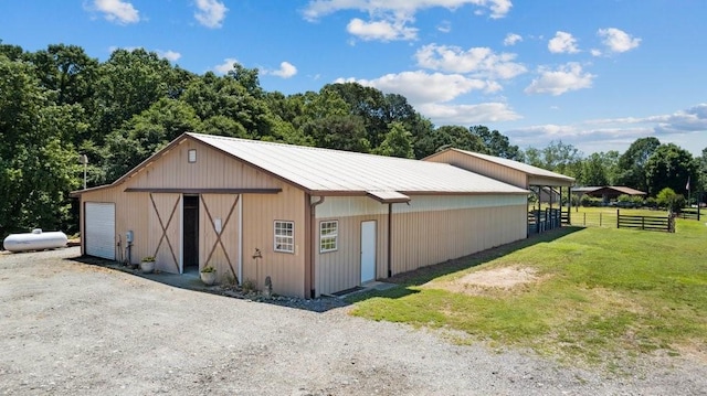 exterior space with a garage and a lawn