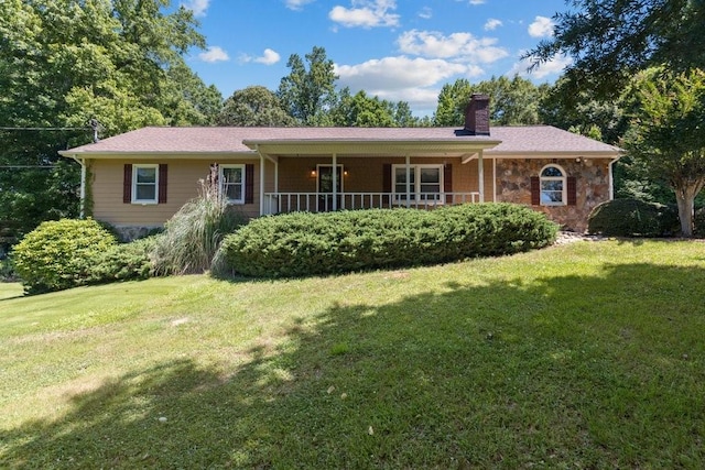 single story home featuring covered porch and a front yard