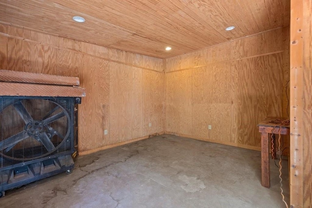 unfurnished living room featuring concrete flooring, wooden ceiling, and wooden walls