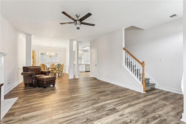 living room featuring stairway, wood finished floors, visible vents, and ornate columns