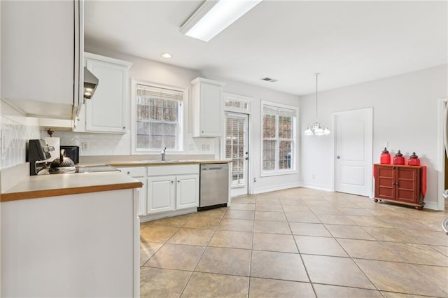 kitchen featuring hanging light fixtures, white cabinets, dishwasher, and light countertops