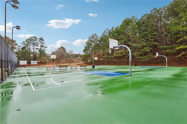 view of basketball court with community basketball court and fence