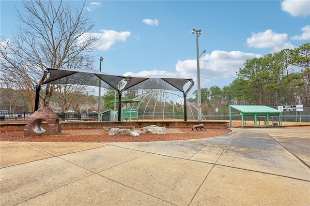 view of jungle gym featuring fence