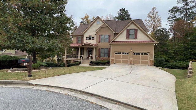 craftsman-style home featuring a porch, a garage, and a front yard