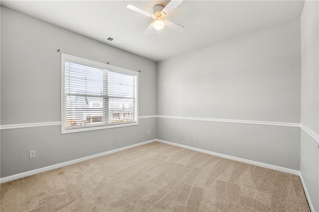 carpeted empty room featuring ceiling fan