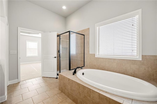 bathroom featuring plus walk in shower and tile patterned floors